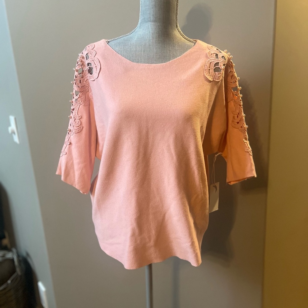 Pink women’s knit sweater with lace sleeve detail